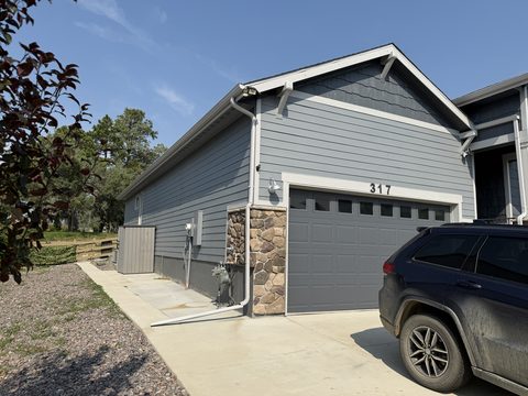 Exterior painting, gray siding garage side, stone accent, Elements Painting project on the Colorado Front Range