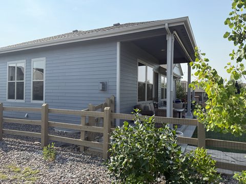 Exterior painting, blue-gray siding rear corner, covered patio, split-rail fence, Elements Painting project on the Colorado Front Range