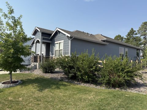 Exterior painting, gray siding front corner from lawn, shrubs, blue sky, Elements Painting project on the Colorado Front Range