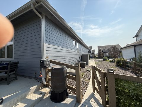 Exterior painting, gray siding side yard, rain barrel, Elements Painting project on the Colorado Front Range