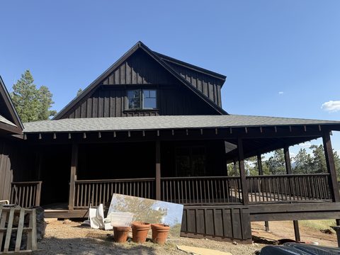 In progress: Dark brown stained cabin with wraparound porch, Elements Painting project on the Colorado Front Range