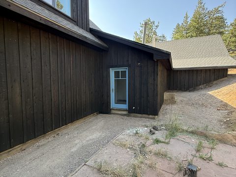 In progress: Dark brown siding with light blue door, Elements Painting project on the Colorado Front Range