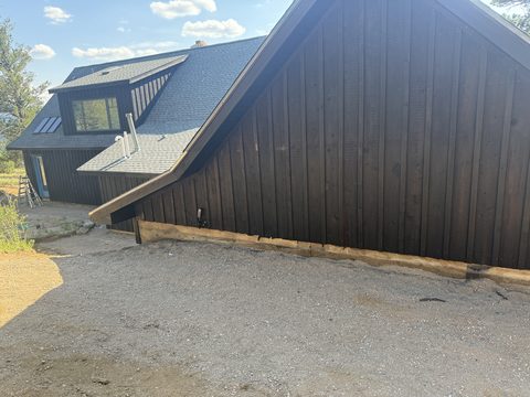 In progress: Dark brown gable with exposed foundation timber, Elements Painting project on the Colorado Front Range