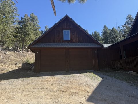 Exterior painting, dark brown stained detached garage, gravel driveway, mountain setting, Elements Painting project on the Colorado Front Range