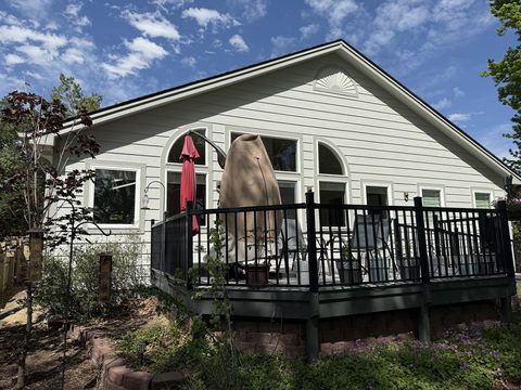 Exterior painting, light grey painted house, white trim, black railing deck, hot tub cover, Elements Painting project on the Colorado Front Range