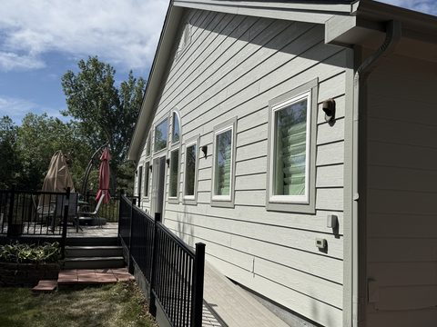 Exterior painting, light grey-green lap siding, white trim, black railing deck, sunny, Elements Painting project on the Colorado Front Range