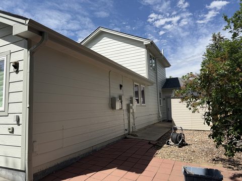 Exterior painting, cream lap siding with tan trim, side yard, Elements Painting project on the Colorado Front Range