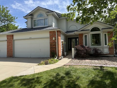 Exterior painting, light sage siding, white trim, brick accents, white three-car garage, Elements Painting project on the Colorado Front Range