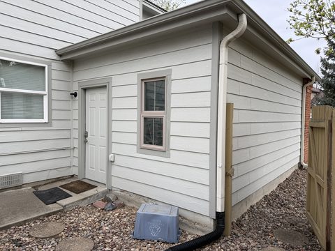 Exterior painting, white siding, grey trim and door, side entry corner, Elements Painting project on the Colorado Front Range