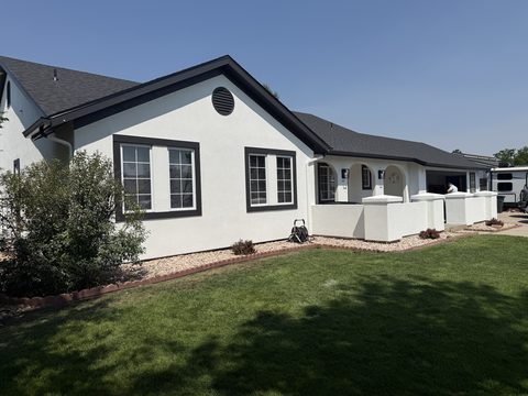 Exterior painting, white stucco, black window trim, arched porch, angled front, Elements Painting project on the Colorado Front Range
