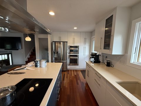 Cabinet painting, white kitchen cabinets, stainless appliances, dark island, Elements Painting project on the Colorado Front Range