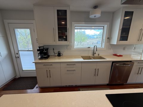 Cabinet painting, white sink-wall cabinets, kitchen window, glass-door uppers, Elements Painting project on the Colorado Front Range