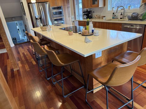 Cabinet painting, kitchen island with wood base, cream quartz top, tan leather stools, hardwood floor, Elements Painting project on the Colorado Front Range