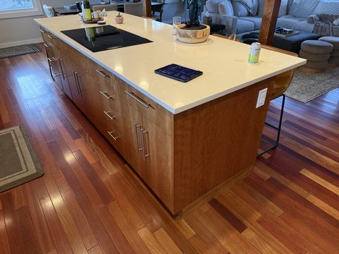 Cabinet painting, side view of wood kitchen island, cream quartz, steel pulls, hardwood floor, Elements Painting project on the Colorado Front Range
