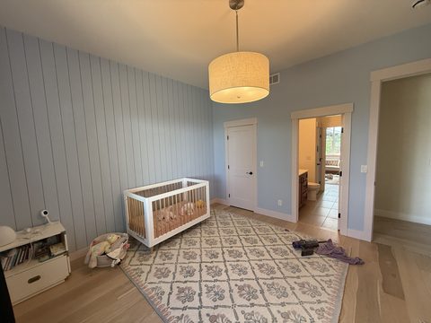Interior painting, nursery with light blue shiplap wall, white crib, drum pendant, Elements Painting project on the Colorado Front Range