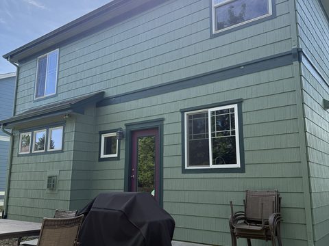 Exterior painting, sage green lap siding, dark teal trim, burgundy door, back patio with grill, Elements Painting project on the Colorado Front Range