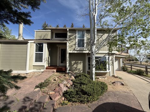Exterior painting, tan olive siding, cream trim, front entry with aspens and rock landscaping, Elements Painting project on the Colorado Front Range