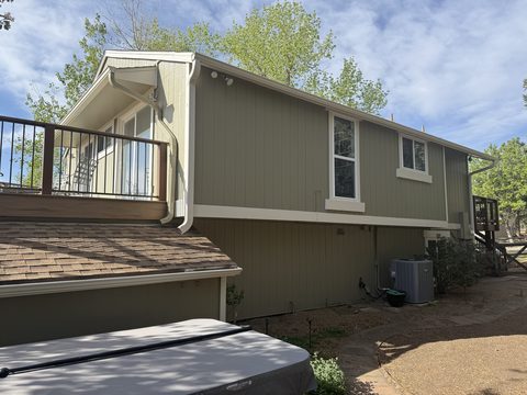 Exterior painting, olive-tan siding rear elevation, deck railing, white trim, hot tub cover, Elements Painting project on the Colorado Front Range