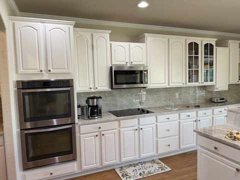 Cabinet painting, white painted kitchen cabinets, stainless appliances, gray countertops, Elements Painting project on the Colorado Front Range