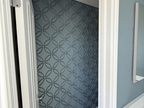 Interior painting, small closet nook with blue-gray geometric patterned wall, white trim, Elements Painting project on the Colorado Front Range