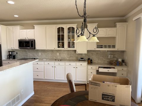 Cabinet painting, white kitchen cabinets, beige walls, Elements Painting project on the Colorado Front Range