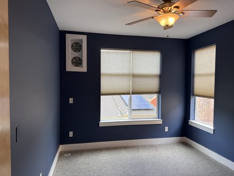 Interior painting, navy blue bedroom, two windows, ceiling fan, Elements Painting project on the Colorado Front Range