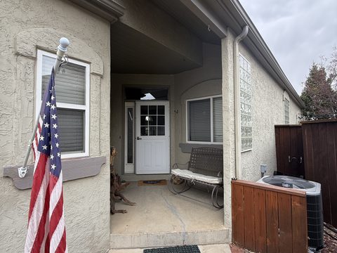 Exterior painting, beige stucco entry porch, white door, American flag, Elements Painting project on the Colorado Front Range
