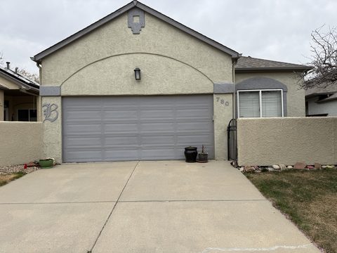Exterior painting, tan stucco front, grey garage door, courtyard wall, Elements Painting project on the Colorado Front Range