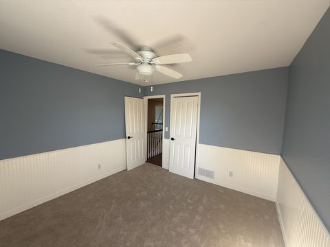 Interior painting, blue-grey walls above white beadboard wainscot, ceiling fan, bedroom, Elements Painting project on the Colorado Front Range