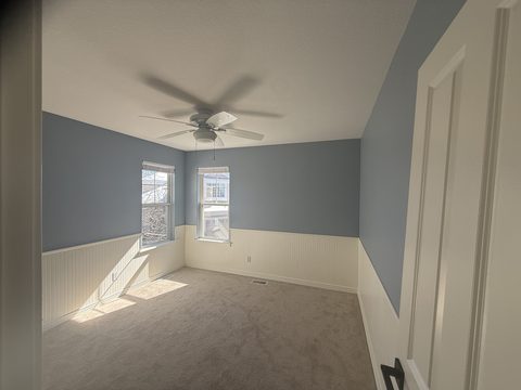 Interior painting, blue-grey walls, white beadboard wainscot, ceiling fan, sunny bedroom, Elements Painting project on the Colorado Front Range