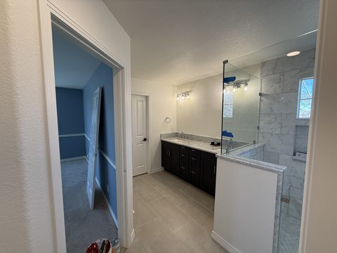 Interior painting, white primary bath, dark cabinets, glass shower, Elements Painting project on the Colorado Front Range