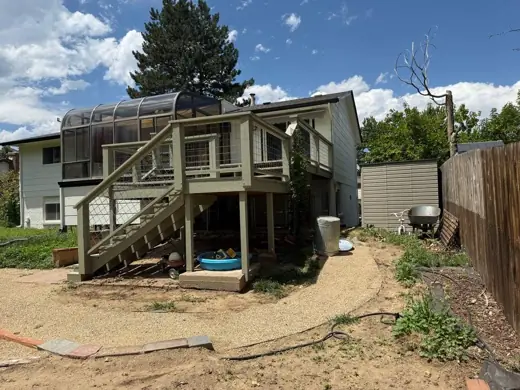 Faded green house with worn deck before painting, Elements Painting project on the Colorado Front Range