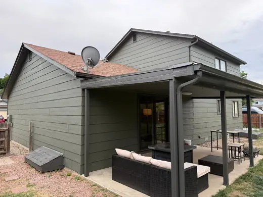Gray-green house with covered patio and dark trim, Elements Painting project on the Colorado Front Range