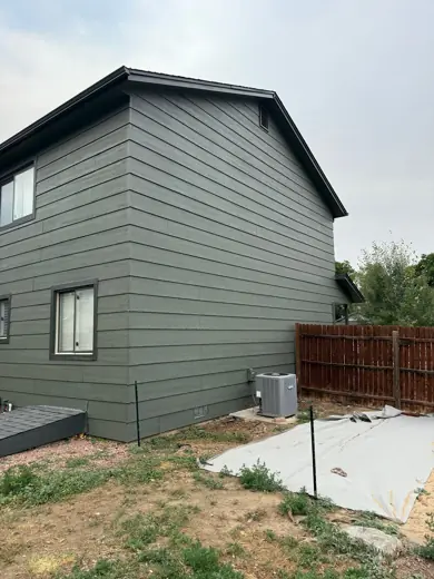 Gray-green sided house with white trim and fence, Elements Painting project on the Colorado Front Range