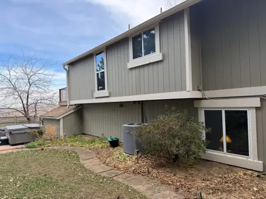 Gray-green two-story home with cream trim, rear view, Elements Painting project on the Colorado Front Range