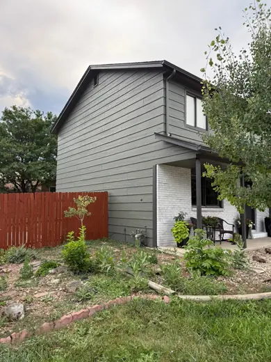 Gray-green two-story house rear with red fence, Elements Painting project on the Colorado Front Range