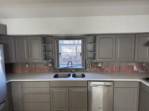 Gray kitchen cabinets with white counters and sink window, Elements Painting project on the Colorado Front Range