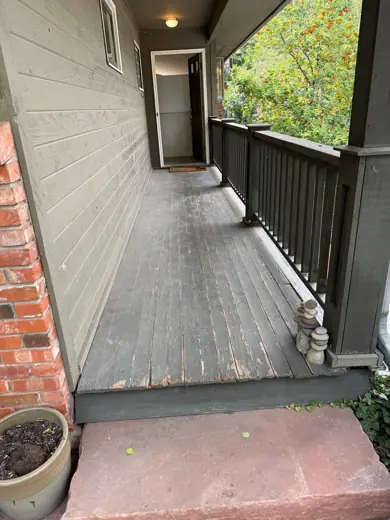 Gray painted deck with dark railing and red brick, Elements Painting project on the Colorado Front Range