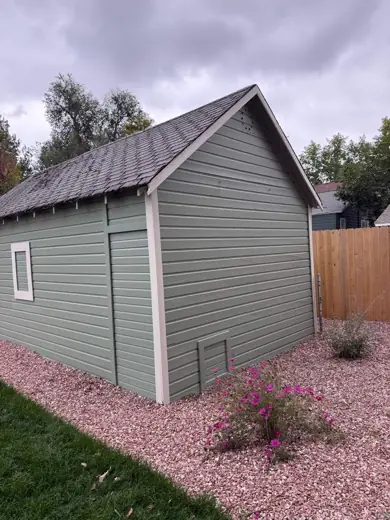Gray shed with white trim on gravel landscaping, Elements Painting project on the Colorado Front Range