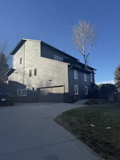 Gray two-story home side view from driveway, Elements Painting project on the Colorado Front Range
