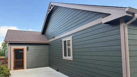 Green sided home with brown trim and red door, Elements Painting project on the Colorado Front Range