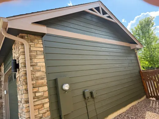 Green siding with stone base and tan trim, Elements Painting project on the Colorado Front Range