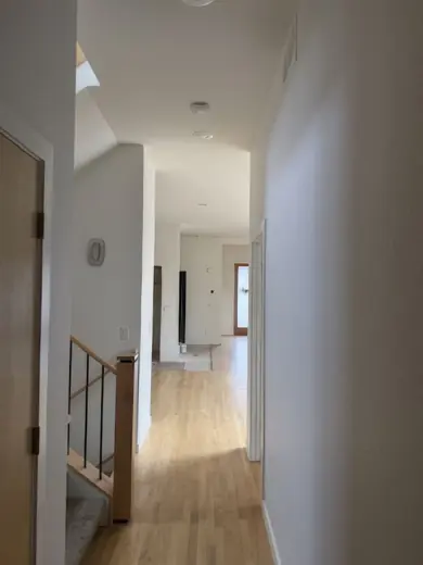 Hallway with white walls and wood floors, Elements Painting project on the Colorado Front Range