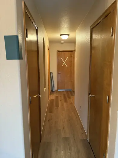 Hallway with wood doors and freshly painted white walls, Elements Painting project on the Colorado Front Range