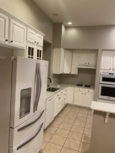 Kitchen with white painted cabinets and white appliances, Elements Painting project on the Colorado Front Range
