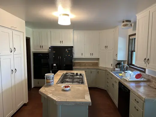 Kitchen with white uppers, sage lowers and granite island, Elements Painting project on the Colorado Front Range