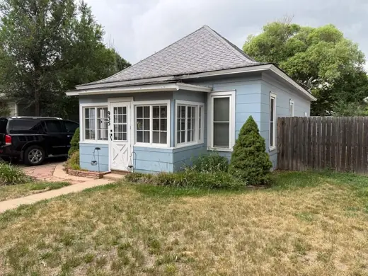 Light blue bungalow with white trim, flagstone patio, Elements Painting project on the Colorado Front Range