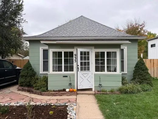 Light blue cottage with white porch trim and windows, Elements Painting project on the Colorado Front Range