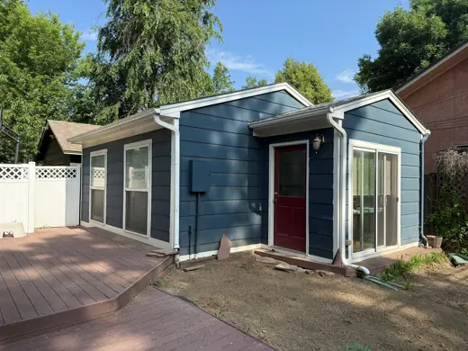 Light blue house rear with red door and deck, Elements Painting project on the Colorado Front Range