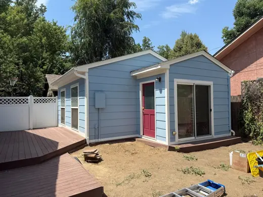 Light blue house with red door and new deck, Elements Painting project on the Colorado Front Range